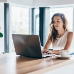 Woman using laptop while sitting at home